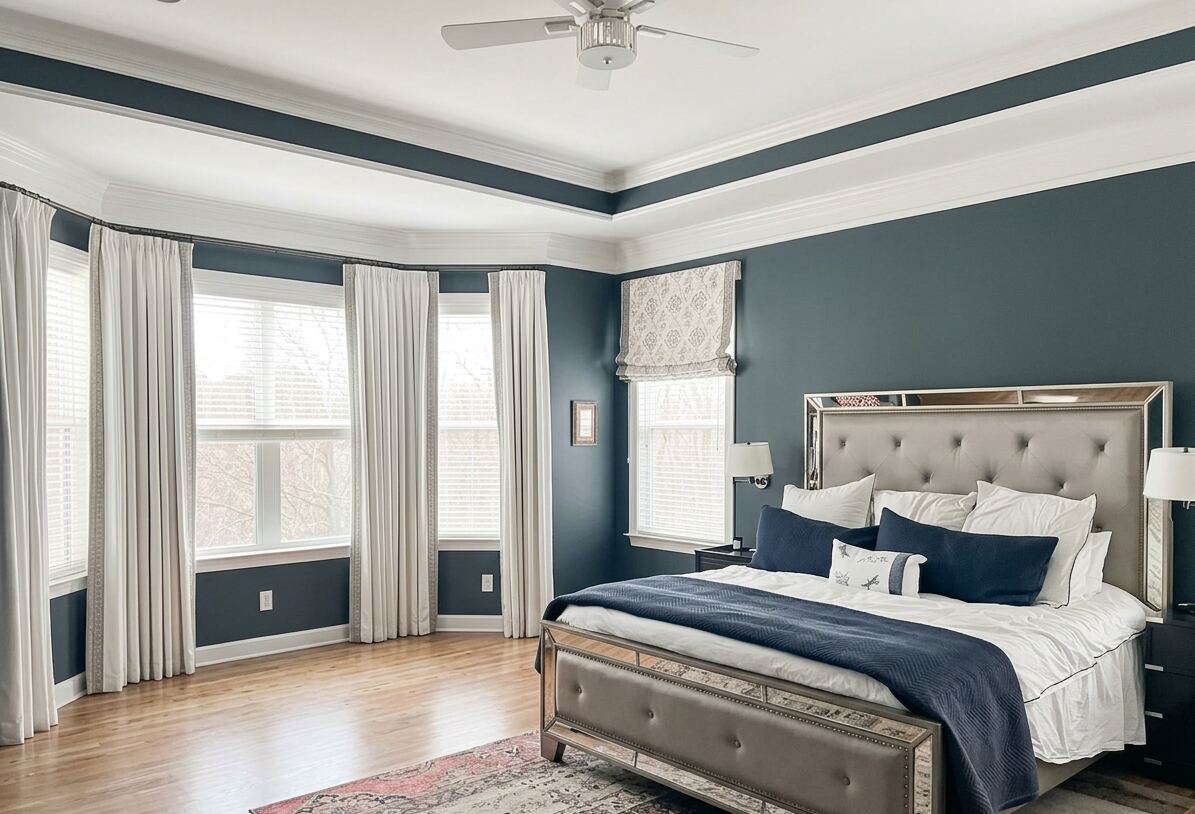 Bedroom repaint with dark blue walls, white trim, crown molding, and large windows